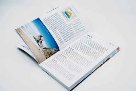 An open book with a picture and text is open on a table